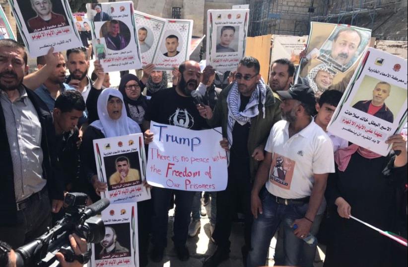 Palestinians protest in solidarity with hunger-striking prisoners in front of the Church of the Nativity in Bethlehem, May 23, 2017. (photo credit: ELIYAHU KAMISHER)