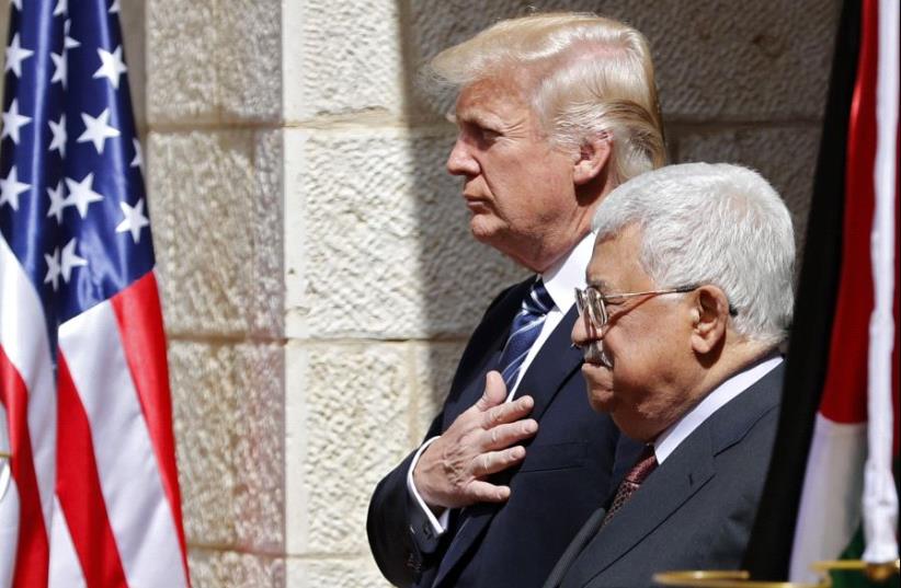 Palestinian Authority President Mahmoud Abbas (R) and US President Donald Trump listen to anthems during a welcome ceremony at the Presidential Palace in Bethlehem on May 23, 2017 (photo credit: THOMAS COEX / AFP)