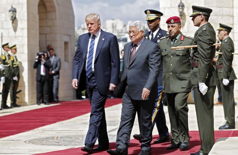 US President Donald Trump (L) and Palestinian leader Mahmud Abbas (2nd L) review the honour guard at the presidential palace in the West Bank city of Bethlehem on May 23, 2017 (photo credit: THOMAS COEX / AFP)