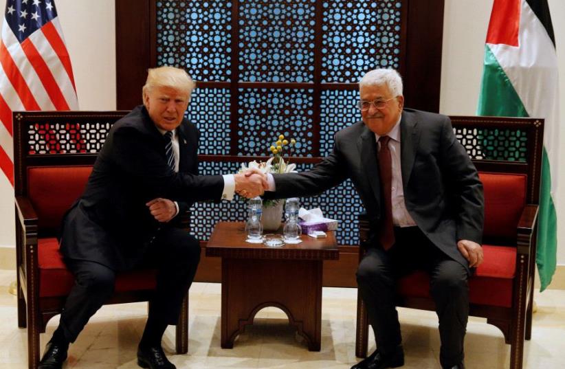 US President Donald Trump shakes hands with Palestinian Authority President Mahmoud Abbas during their meeting at the presidential headquarters in the West Bank town of Bethlehem, May 23, 2017 (photo credit: REUTERS)