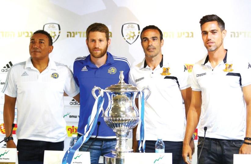 The coaches and captains of Maccabi Tel Aviv and Bnei Yehuda – (from left) Lito Vidigal and Sheran Yeini of Maccabi Tel Aviv and Bnei Yehuda’s Kfir Edri and Itzik Azuz – pose with the State Cup ahead of the final between the teams at Jerusalem’s Teddy Stadium. (photo credit: ADI AVISHAI)