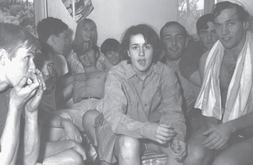 A group of foreign volunteers who came in August 1967 to clean up the university’s premises after the war, gathering after work in one of the rooms at their living quarters on Mount Scopus, Jerusalem (photo credit: MOSHE MILNER / GPO)