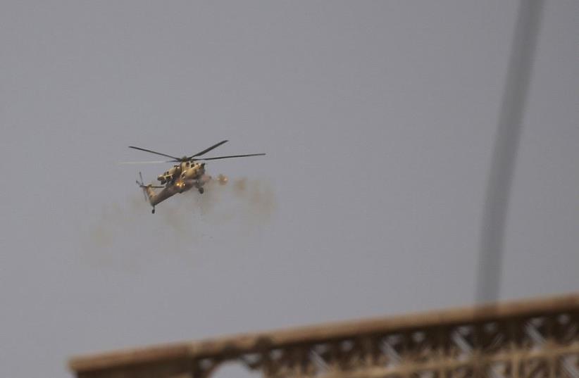 A helicopter of the Iraqi Army fires against Islamic State positions in western Mosul, Iraq May 27, 2017.  (photo credit: REUTERS/ALKIS KONSTANTINIDIS)