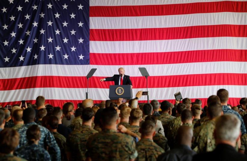 US President Donald Trump delivers remarks to U.S. military personnel at Naval Air Station Sigonella following the G7 Summit, in Sigonella, Sicily, Italy, May 27, 2017. (photo credit: REUTERS/DARRIN ZAMMIT LUPI)