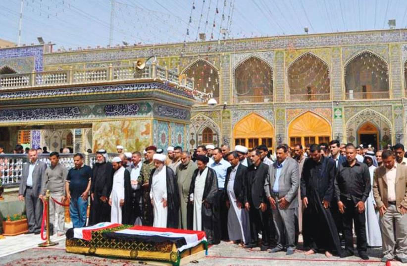 RESIDENTS PRAY near the coffin of Shaima Alawadi at the Imam Ali shrine in Najaf. (photo credit: REUTERS)