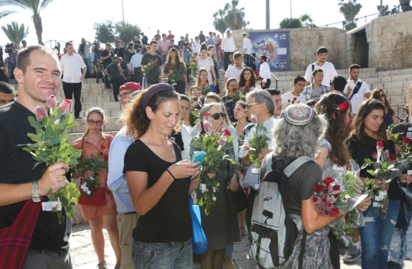 On Jerusalem Day last Wednesday, members of the Tag Meir movement presented flowers to passersby in the Old City’s Muslim Quarter (photo credit: YOSSI ZAMIR/TAG MEIR)