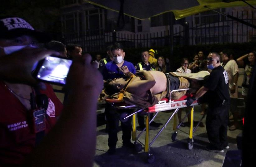 An injured hotel guest is seen outside of a hotel after a shooting incident inside Resorts World Manila in Pasay City, Metro Manila, Philippines June 2, 2017 (photo credit: REUTERS/STRINGER)