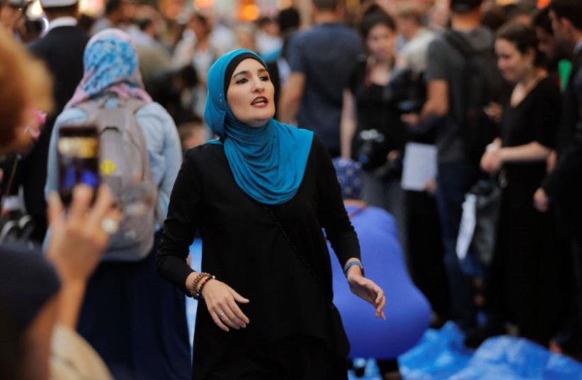 Activist Linda Sarsour prepares for the beginning of a demonstration and Iftar celebration during Ramadan outside of Trump Tower in New York, U.S., June 1, 2017 (photo credit: REUTERS)