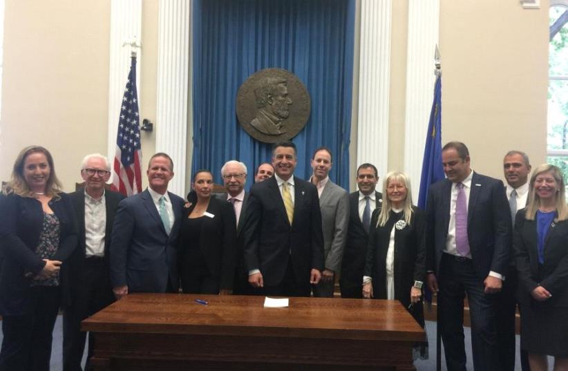 Governor Brian Sandoval after signing anti-BDS into law. (photo credit: Courtesy)