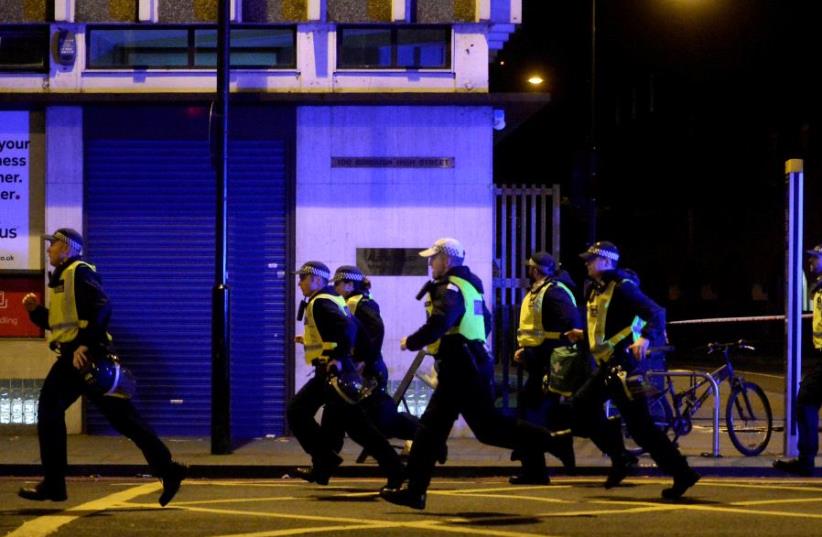 Police attend to an incident on London Bridge in London, Britain, June 3, 2017. (photo credit: REUTERS / HANNAH MCKAY TPX)