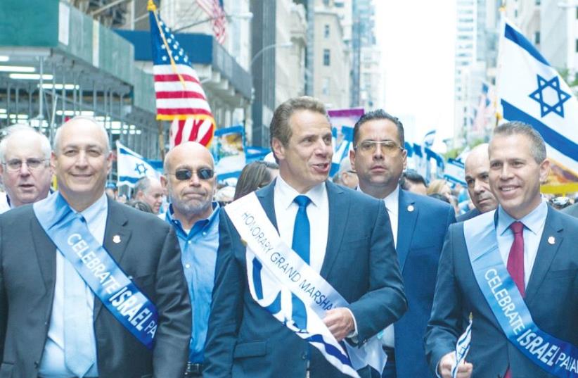 STRATEGIC AFFAIRS MINISTER Gilad Erdan (right) marches in New York City’s Celebrate Israel Parade as Gov. Andrew Cuomo stands between him and Chemi Peres yesterday. (photo credit: ALEXI ROSENFELD)