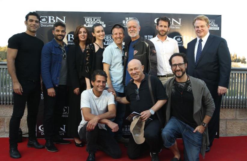 CBN CEO Gordon Robertson (far right, back row) and director Erin ZImmerman (third from left, back row) poses with cast and crew members of the network's docudrama, In Our Hands, which was screened in Jerusalem on Sunday. (photo credit: ISAAC E. GWIN CBN)
