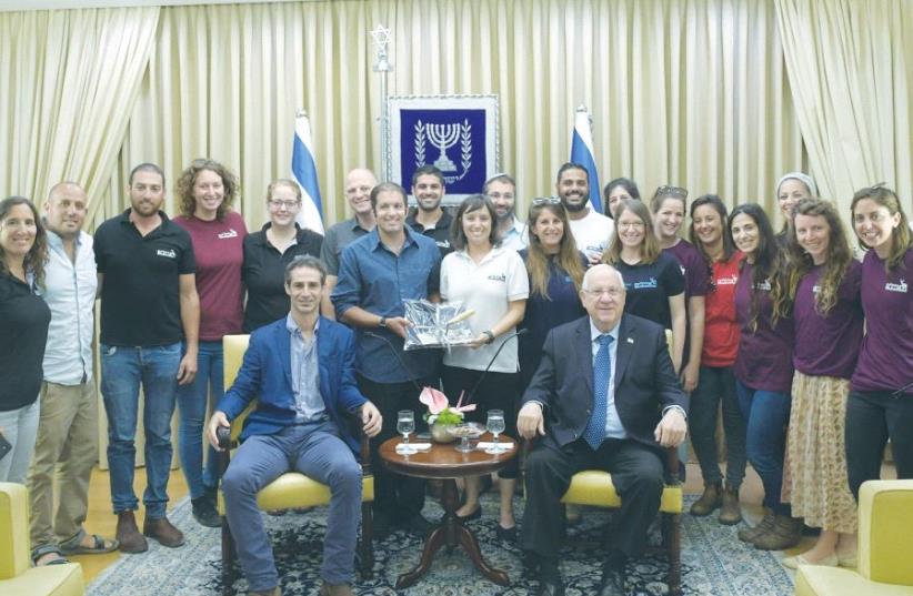 PRESIDENT REUVEN RIVLIN poses with managers of Ayalim, an organization that operates student-run villages in the Negev, Galilee and other peripheral areas, at the President’s Residence yesterday. (photo credit: AMOS BEN GERSHOM, GPO)