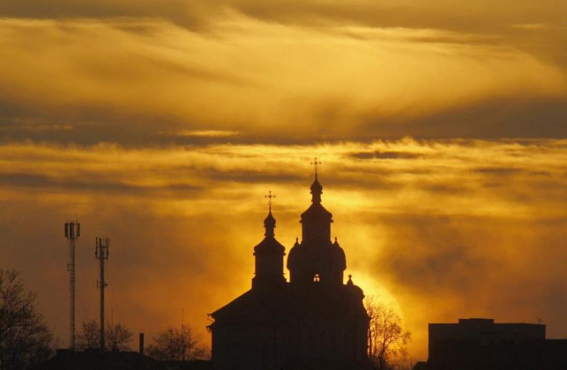 The sun rises above an Orthodox Church in the town of Novogrudok, 150 km (93 miles) west of the Belarussian capital Minsk (photo credit: REUTERS/VLADIMIR NIKOLSKY)