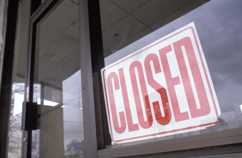 Vacant department store with closed sign in window (photo credit: INGIMAGE PHOTOS)