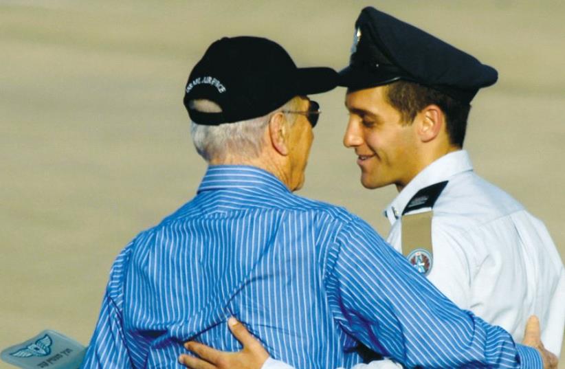 Assaf Ramon (right) stands with then-president Shimon Peres during his graduation ceremony at Hatzerim air base, southern Israel, in June 2009 (photo credit: AMIR COHEN - REUTERS)