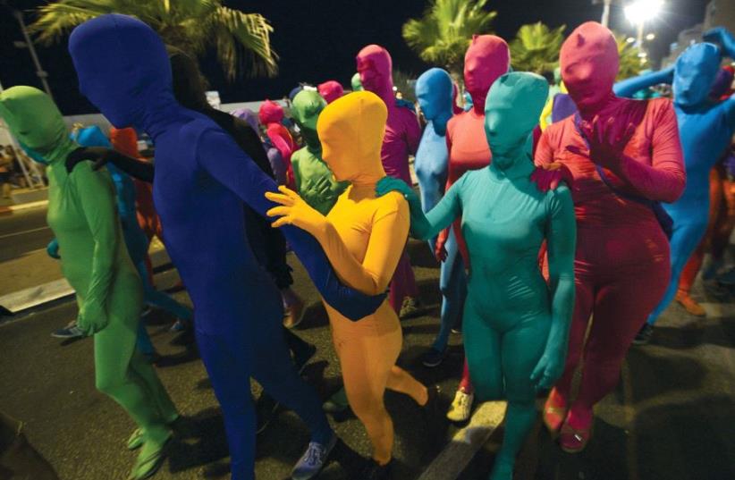 People wear full body costumes (illustrative) (photo credit: ILLUSTRATIVE/AMIR COHEN/REUTERS)