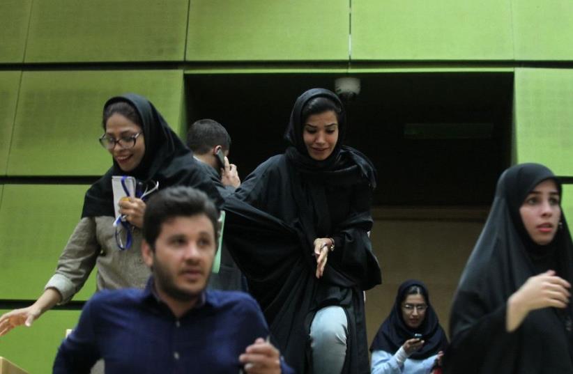 Women are seen inside the parliament during an attack in central Tehran, Iran, June 7, 2017.  (photo credit: TIMA VIA REUTERS)