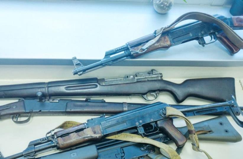 AMONG THE WEAPONS were a sniper rifle from 1890, two revolvers, two Kalashnikov rifles, five pistols, cartridges and bullets. (photo credit: POLICE SPOKESPERSON'S UNIT)