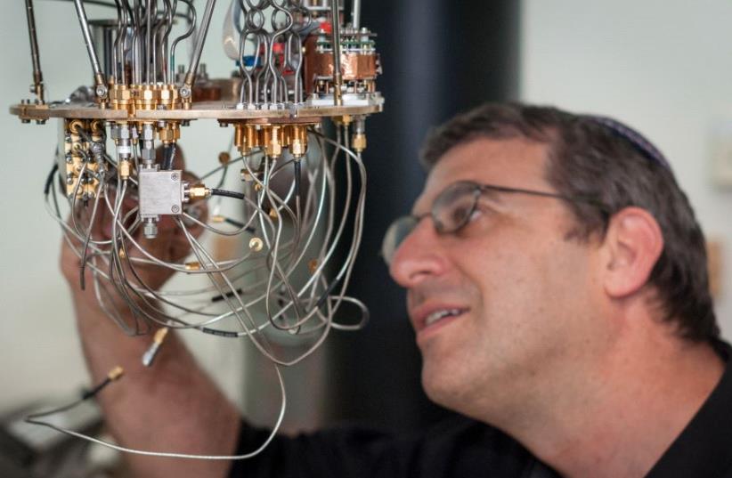 Prof. Nadav Katz with a low temperature setup for testing superconducting detectors at the Hebrew University's Quantum Information Science Center (photo credit: YITZ WOOLF FOR HEBREW UNIVERSITY)