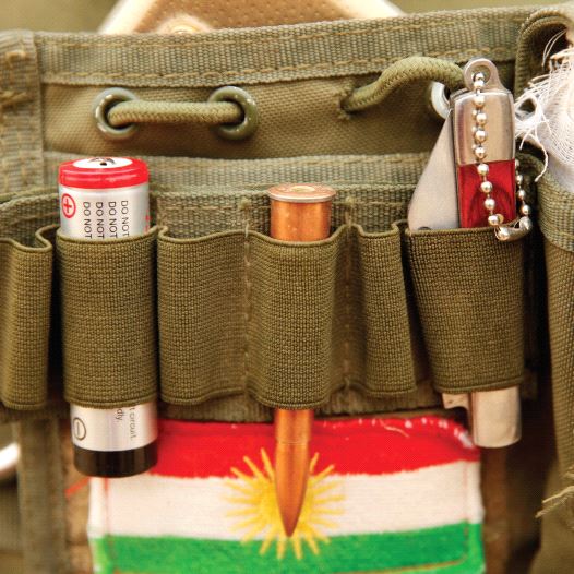 A BULLET and the Kurdistan flag are seen on a Peshmerga fighter’s vest during a battle with ISIS near Bashiqa, Iraq, last year.  REUTERS