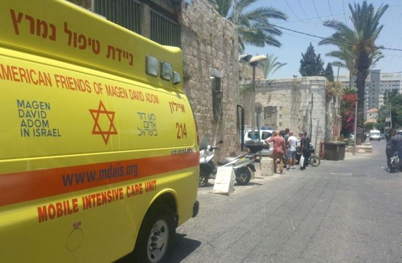 Photo of the scene outside the apartment in Ramle, where an a 17-year-old woman was found dead on Tuesday.  (photo credit: COURTESY MDA)