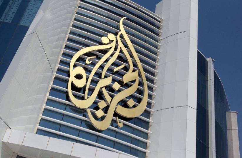 The logo of Al Jazeera Media Network is seen on its headquarters building in Doha, Qatar June 8, 2017. (photo credit: REUTERS/NASEEM ZEITOON/FILE PHOTO)