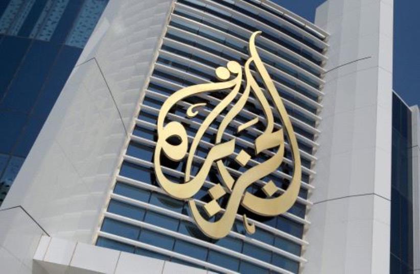 The logo of Al Jazeera Media Network is seen on its headquarters building in Doha, Qatar June 8, 2017. (photo credit: REUTERS/NASEEM ZEITOON/FILE PHOTO)