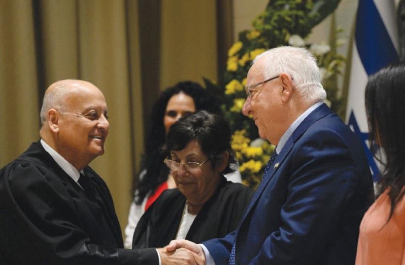 PRESIDENT REUVEN RIVLIN congratulates Supreme Court Deputy President Salim Joubran at his swearing-in ceremony yesterday, as the court’s president, Miriam Naor (center), and Justice Minister Ayelet Shaked stand by (photo credit: CHAIM ZACH / GPO)
