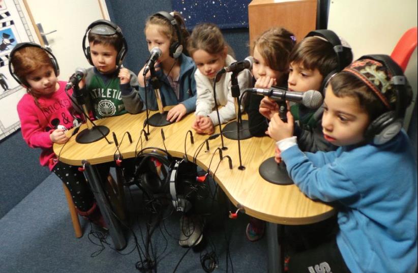 Recording a story in the studio. Gan Hova preschoolers participate in day-long programs exposing them to photography, radio, ads, production of a book and video clips (photo credit: THE MEDIA CENTER)