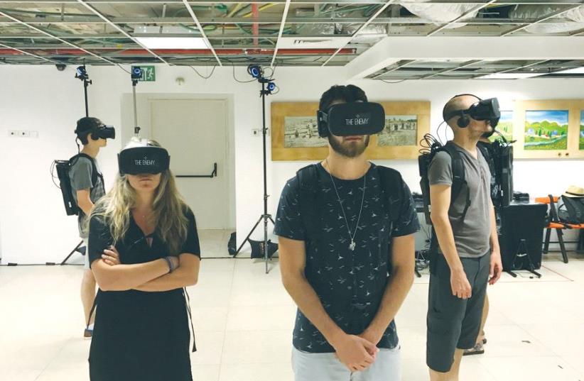 VIEWERS USE virtual-reality headsets to watch enemy combatants answer provocative questions at the Tel Aviv International Student Film Festival on Sunday. (photo credit: ELIYAHU KAMISHER)