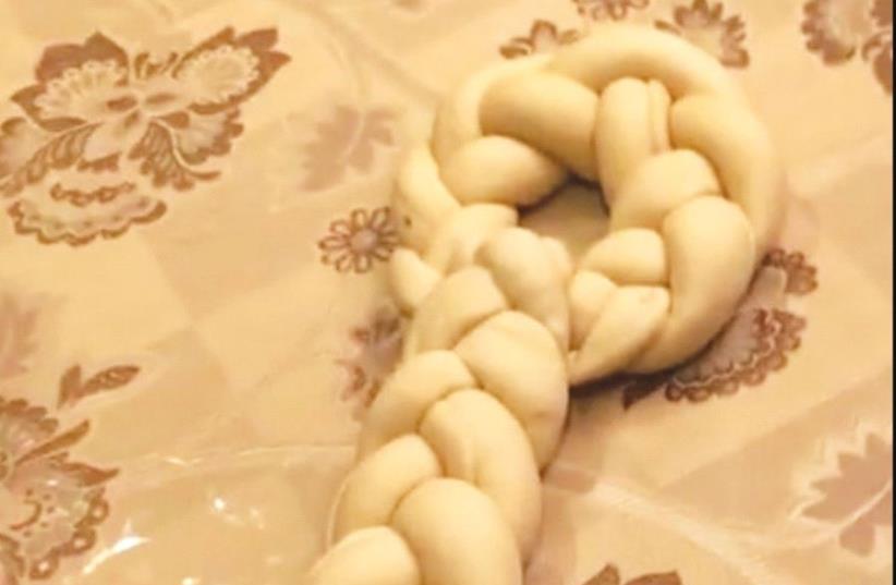 A ‘key halla,’ which is baked on the Shabbat after Passover and symbolizes the key to livelihood. (photo credit: YOUTUBE)