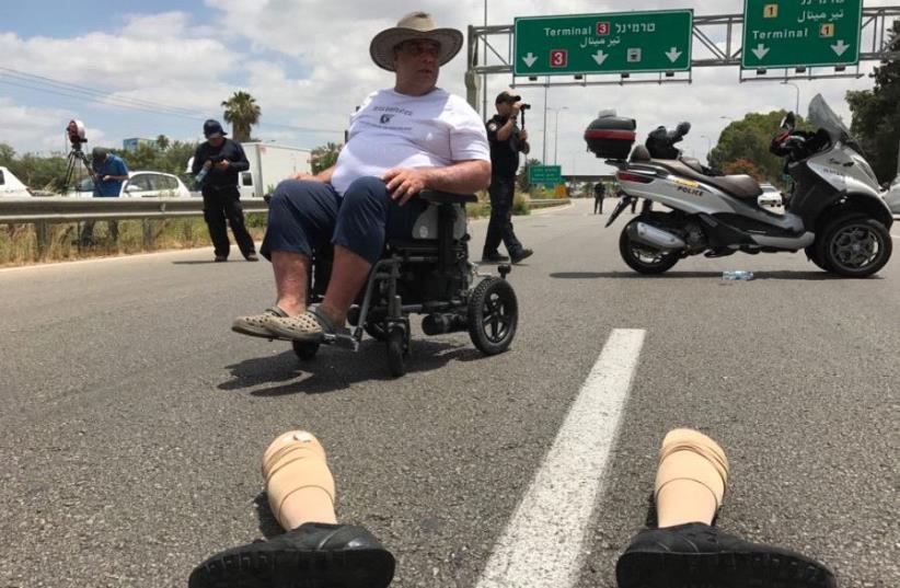 People with disabilities protest next to Ben Gurion airport (photo credit: AVSHALOM SASSONI)