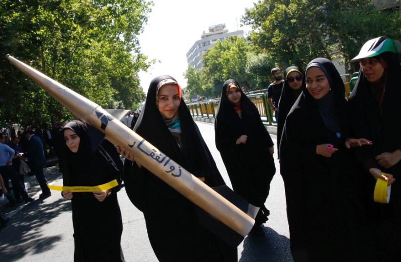 An Iranian girl holds a model of a missile during a rally marking al-Quds (Jerusalem) Day in Tehran on June 23, 2017. (photo credit: STRINGER / AFP)