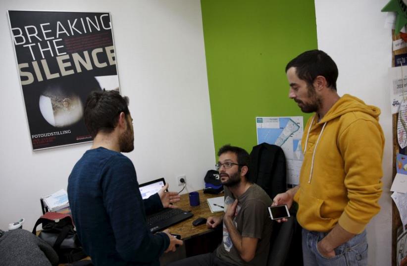 Employees work at the offices of "Breaking the Silence" in Tel Aviv, Israel, December 16, 2015 (photo credit: REUTERS)
