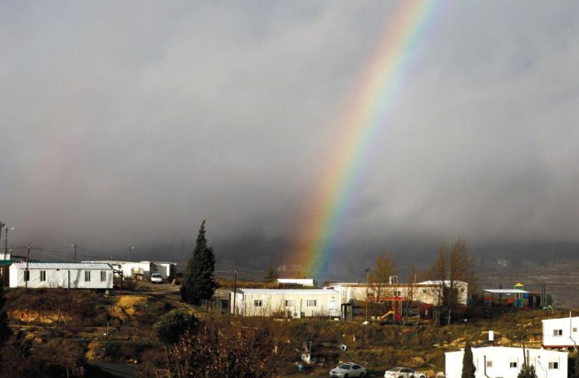 A rainbow is seen over the settler outpost of Amona earlier this year (photo credit: RONEN ZVULUN / REUTERS)