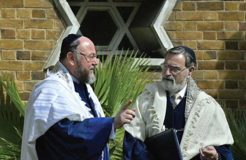 UK Chief Rabbi Ephraim Mirvis with his predecessor, Rabbi Jonathan Sacks (photo credit: TOBY MELVILLE/REUTERS)