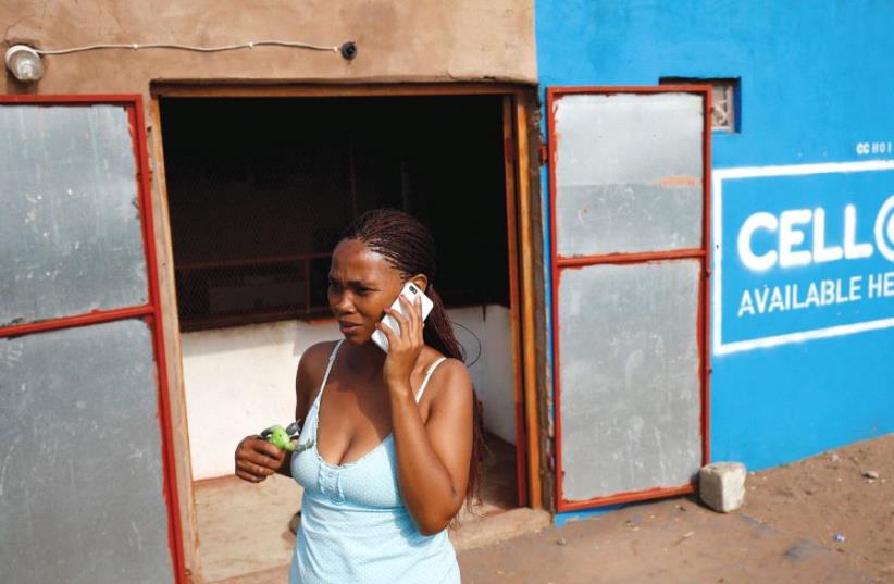 Woman in Africa talking on a smartphone (photo credit: REUTERS)