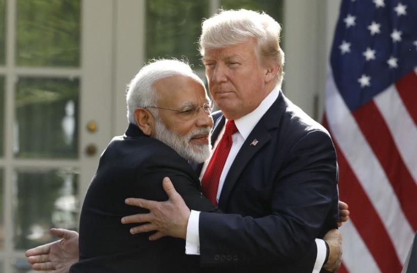 Trump and Modi embrace at the White House, 2017 (photo credit: KEVIN LAMARQUE/REUTERS)