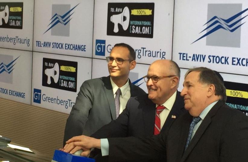 Rudy Giuliani (center) rings the opening bell at the Tel Aviv Stock Exchange, June 28 2017. (photo credit: JULIA BAYER)