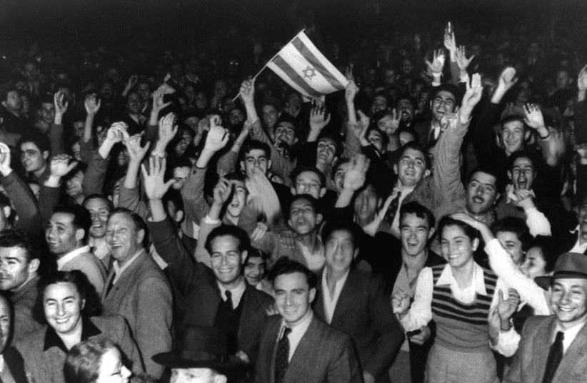 Jews celebrate in the streets of Tel Aviv moments after the United Nations voted on November 29, 1947, to partition Palestine which paved the way for the creation of the State of Israel on May 15, 1948. (photo credit: REUTERS)
