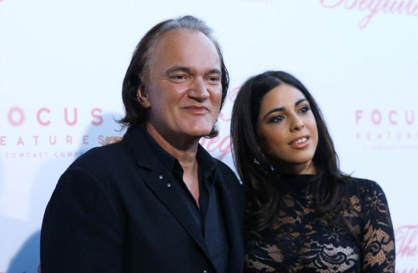Director Quentin Tarantino and Daniela Pick pose at a premiere for 'The Beguiled' in Los Angeles, June 12, 2017 (photo credit: REUTERS/MARIO ANZUONI)