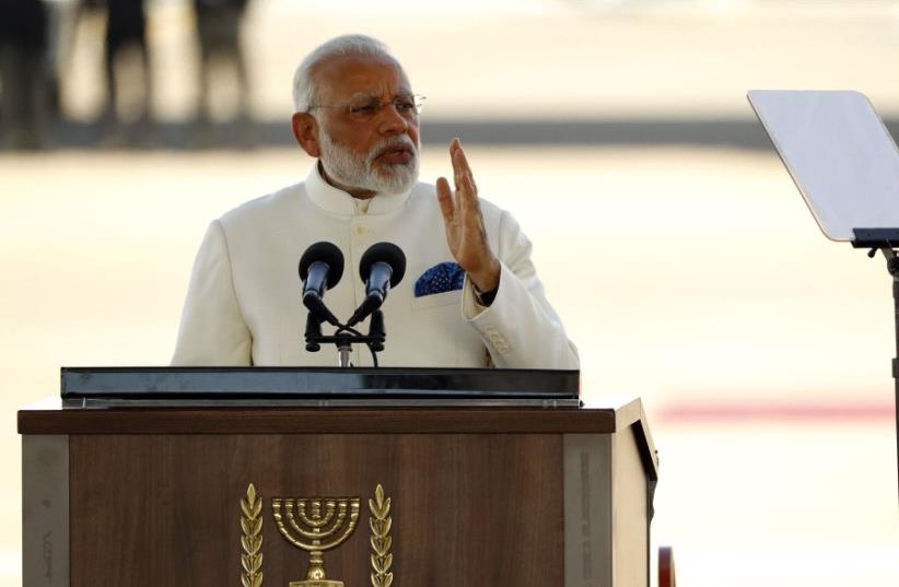 Indian Prime Minister Narendra Modi speaks during his welcoming ceremony in the presence of his Israeli counterpart Benjamin Netanyahu (not in frame) at Ben-Gurion International airport near Tel Aviv on July 4, 2017 (photo credit: JACK GUEZ / AFP)