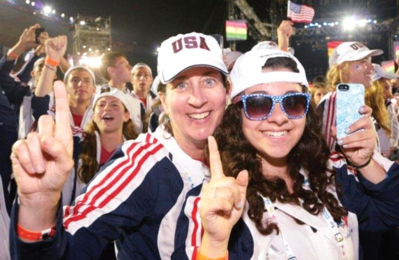 Sherry Levin (left) poses for a photo alongside her daughter, Marcia, during the opening ceremony of the 19th Maccabiah four years ago. Levin, who was with the USA’s U-18 Girls’ squad in 2013, will serve as the head coach of the US Women’s Open basketball team this summer, a remarkable accomplishmen (photo credit: Courtesy)