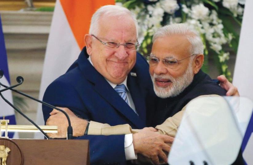 PRESIDENT REUVEN RIVLIN receives a bear hug from Indian Prime Minister Narendra Modi during Rivlin’s visit to India last November (photo credit: REUTERS)