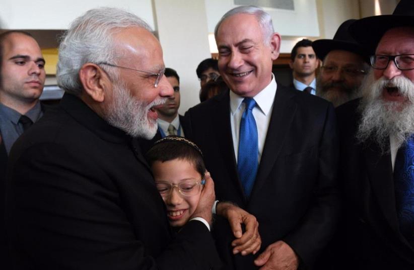 Visiting Indian Prime Minister Narendra Modi with Israeli youth Moshe Holtzberg 5th July 2017. (photo credit: CHAIM TZACH/GPO)
