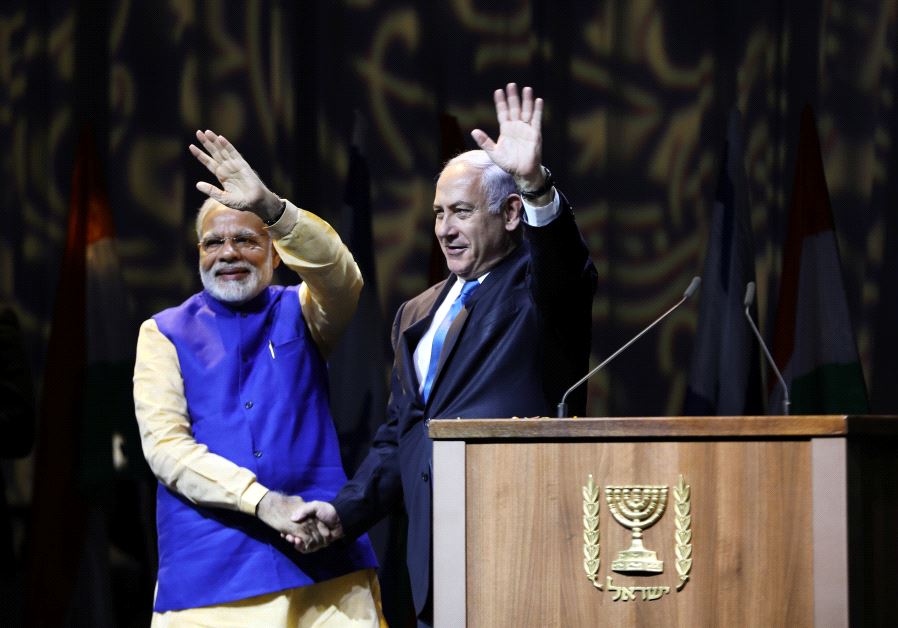 Indian Prime Minister Narendra Modi (L) and Israeli Prime Minister Benjamin Netanyahu shake hands as they wave to the crowd during a reception for the Indian community in Israel, in Tel Aviv, Israel July 5, 2017.