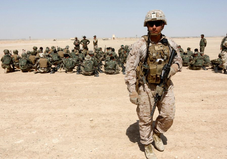 A US Marine walks near Afghan National Army (ANA) soldiers during training in Helmand province, Afghanistan, July 5, 2017. (REUTERS/OMAR SOBHANI)
