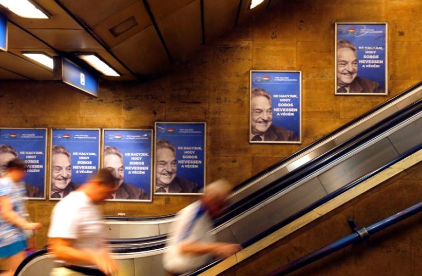 Hungarian government poster portraying financier George Soros and saying "Don't let George Soros have the last laugh" is seen at an underground stop in Budapest, Hungary July 11, 2017.  (photo credit: REUTERS/LASZLO BALOGH)