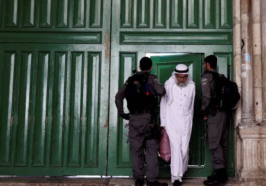 A Muslim worshiper exist the Temple Mount compound atfer its closure follwoing a terror attack (credit: Ammar Awad/ Reuters)